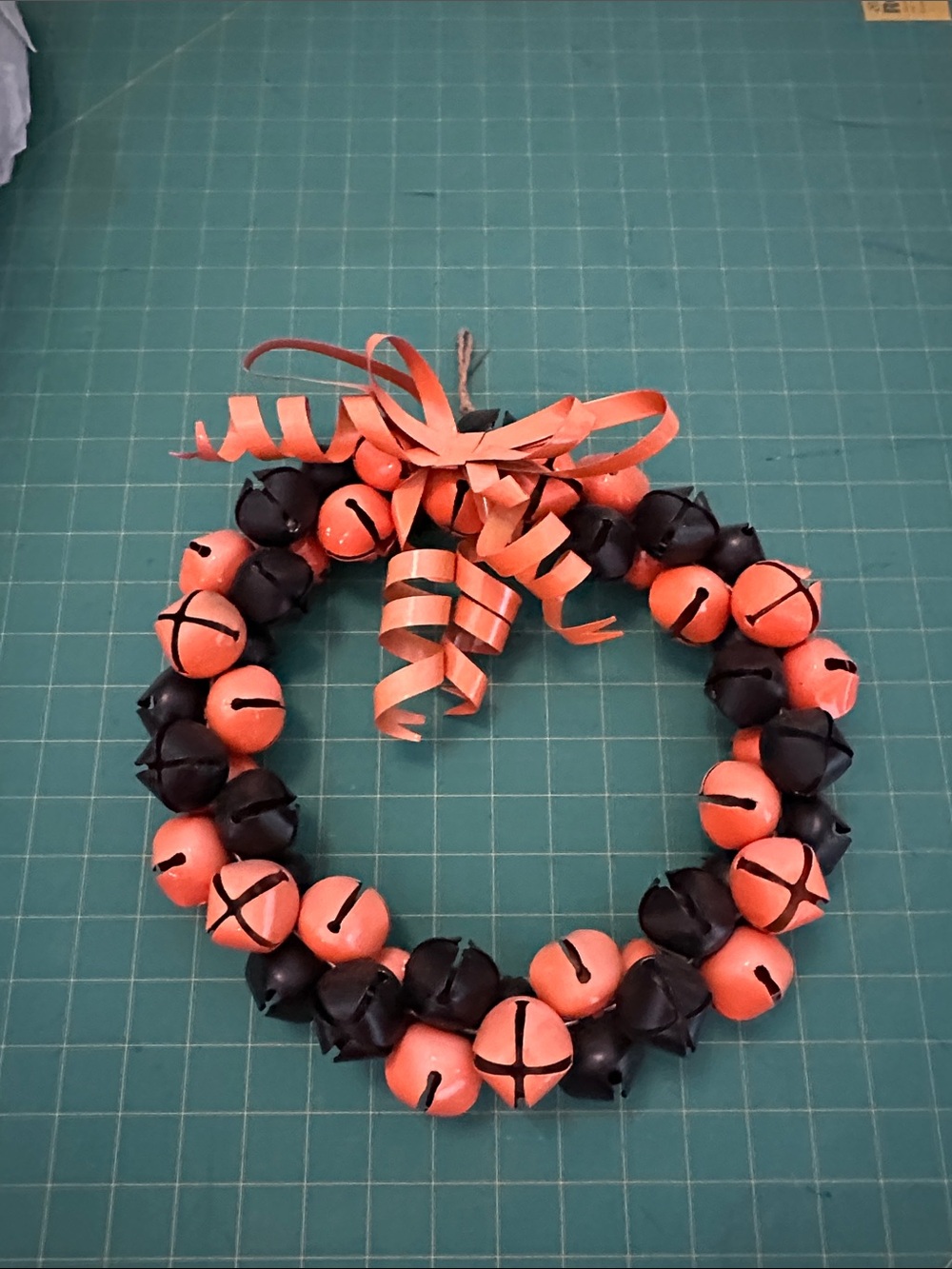 Orange and Black Jingle Bell Holiday Wreath with Curled Ribbon
